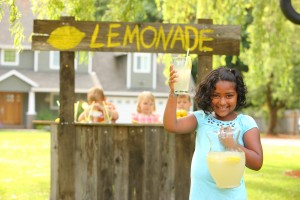 Young girl in front of lemonade stand