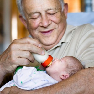 grandfather-feeding-grandchild-a-bottle_web