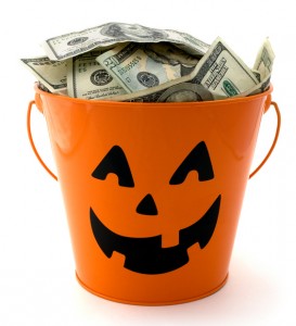 Isolated halloween bucket filled with cash.