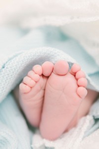 baby feet wrapped in blue blanket