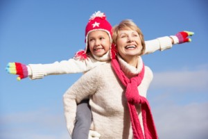 Grandmother Giving Her Granddaughter A Piggy Back Ride